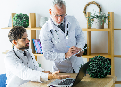 elderly-doctor-making-notes-while-helping-colleague - Axis Integrated Mental Health