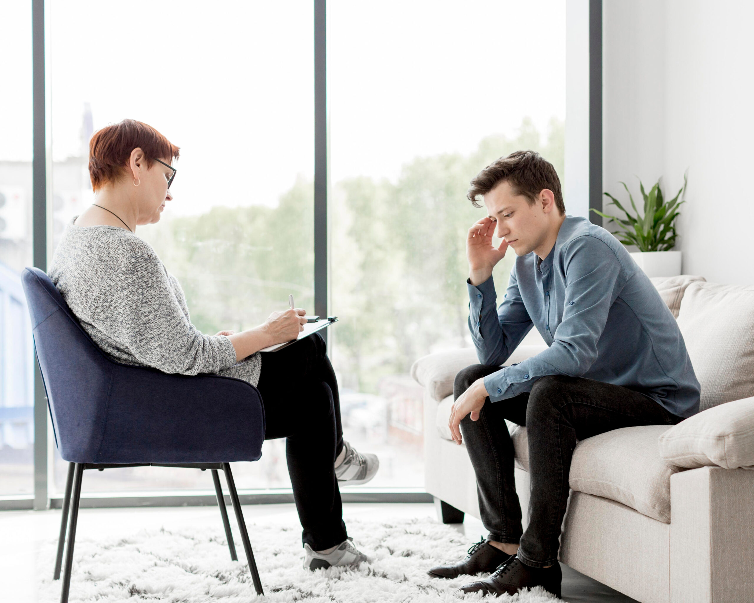 front-view-psychologist-consulting-patient - Axis Integrated Mental Health