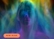 Neon-colored portrait with blue, purple, and green lighting; peach badge reads NEW BLOG, announcing a new post.